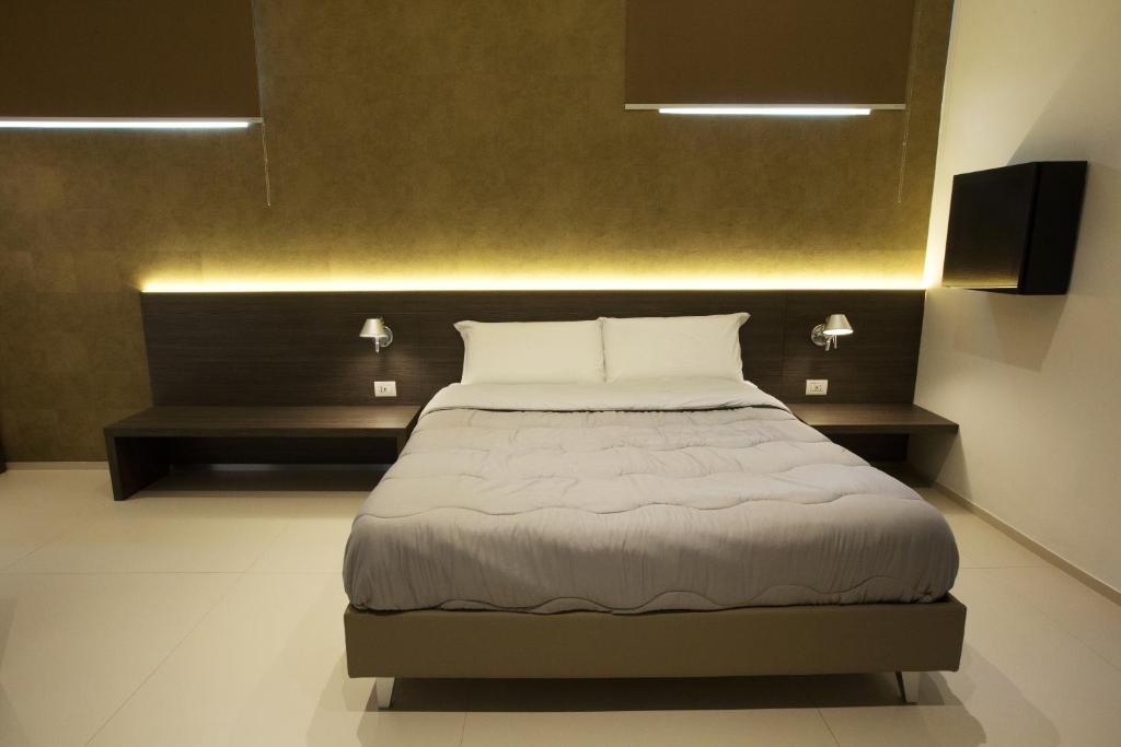 Postel nebo postele na pokoji v ubytování Hotel New Bari