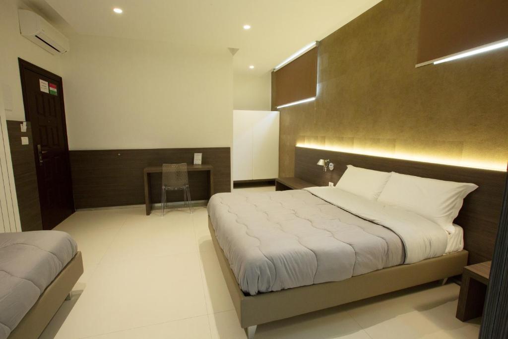Postel nebo postele na pokoji v ubytování Hotel New Bari