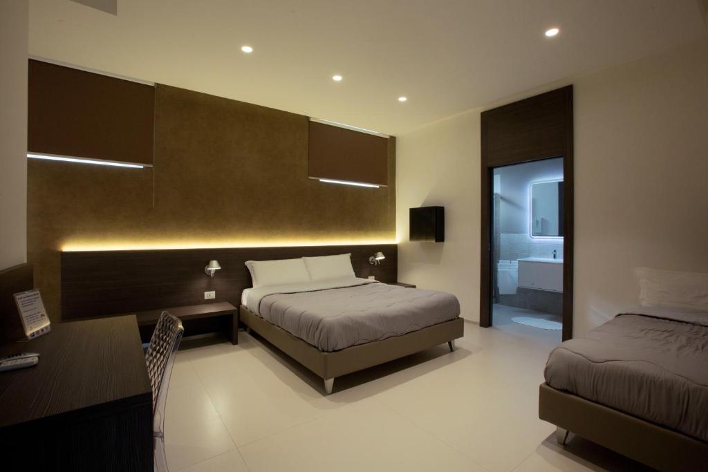 Postel nebo postele na pokoji v ubytování Hotel New Bari