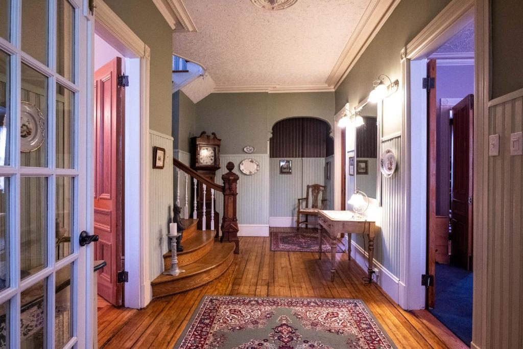 a hallway with green walls and wooden floors at The Lark & Loon Inn in Annapolis Royal