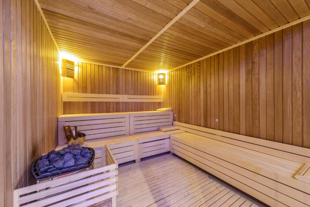 a sauna with wooden walls and a wooden floor at Tasia Maris Beach Hotel - Adults Only in Ayia Napa
