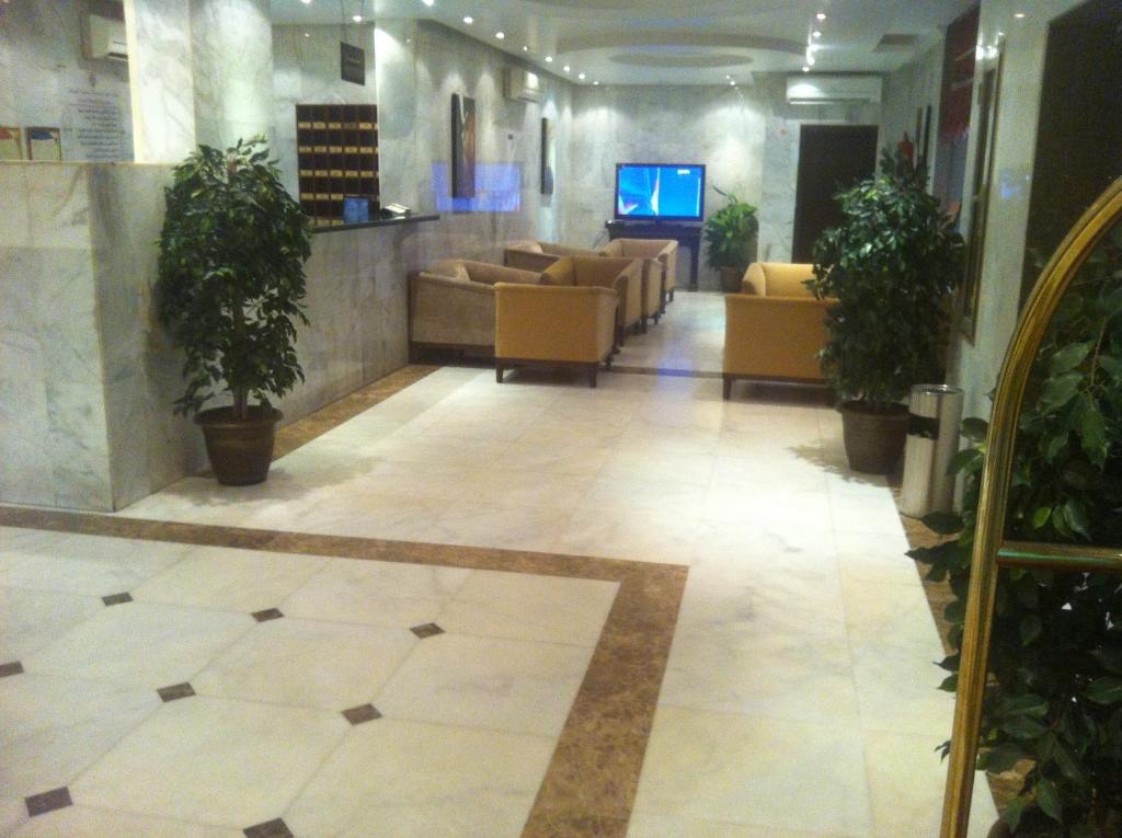 a lobby with couches and potted plants in a building at Makarim Najd Apartments 3 in Riyadh