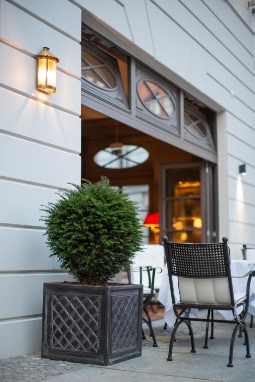 a porch with two chairs and a potted plant at Monbijou Hotel in Berlin