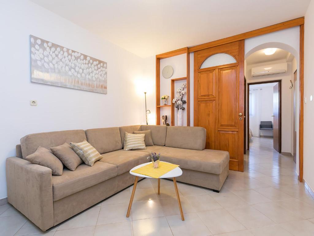 a living room with a couch and a table at Apartment Vita in Poreč