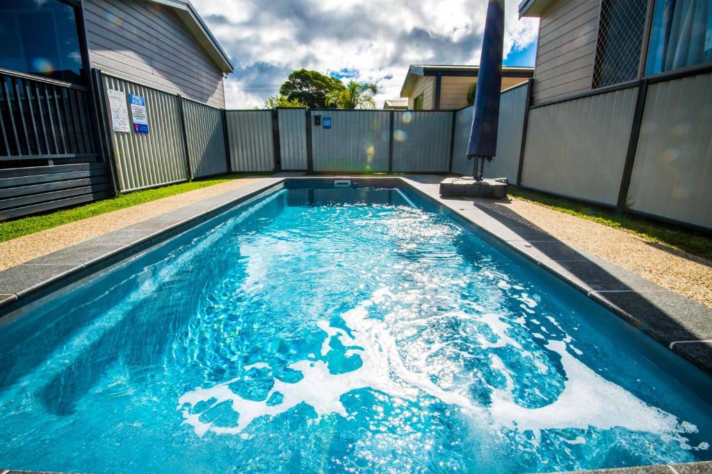 
a pool of water with a blue sky at Clarence Head Caravan Park in Iluka

