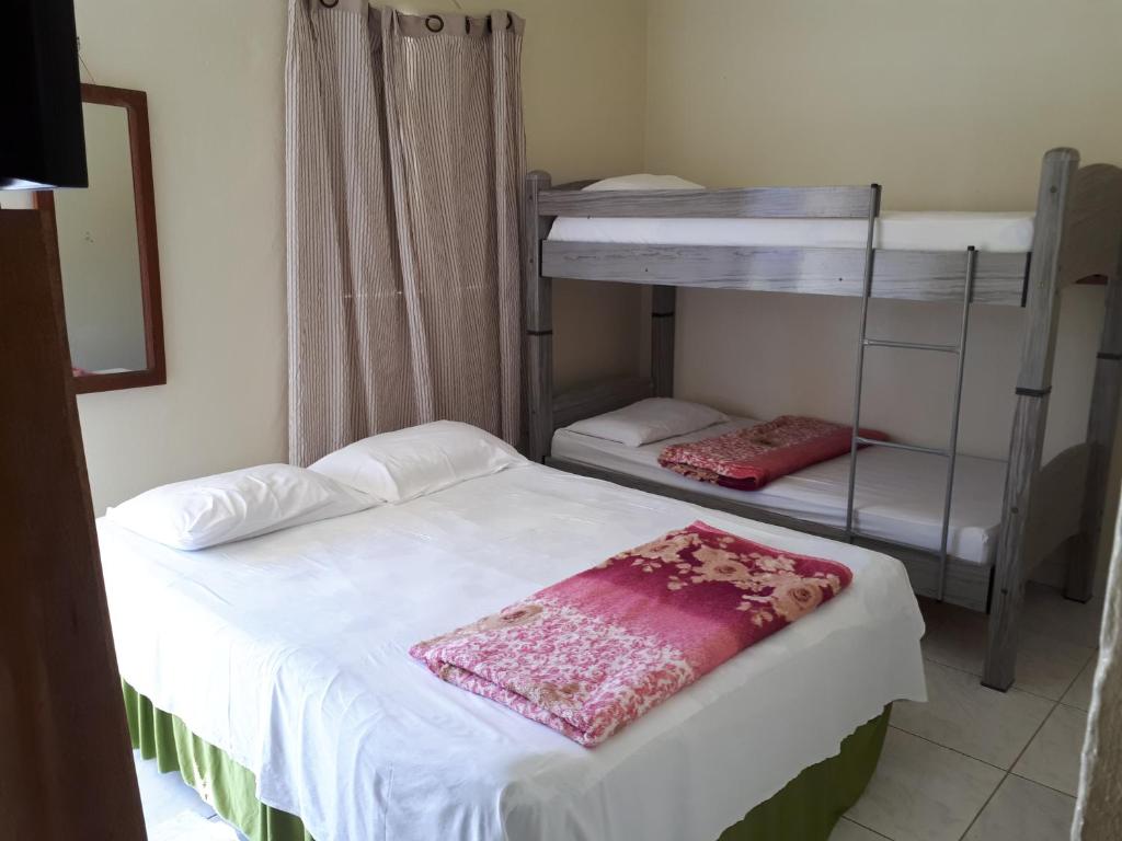 Postel nebo postele na pokoji v ubytování Pousada Cattleya