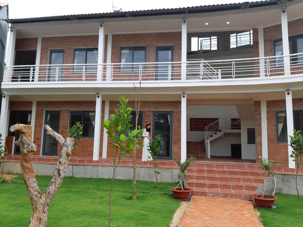 a brick house with a balcony on top of it at Linkin House in Phu Quoc