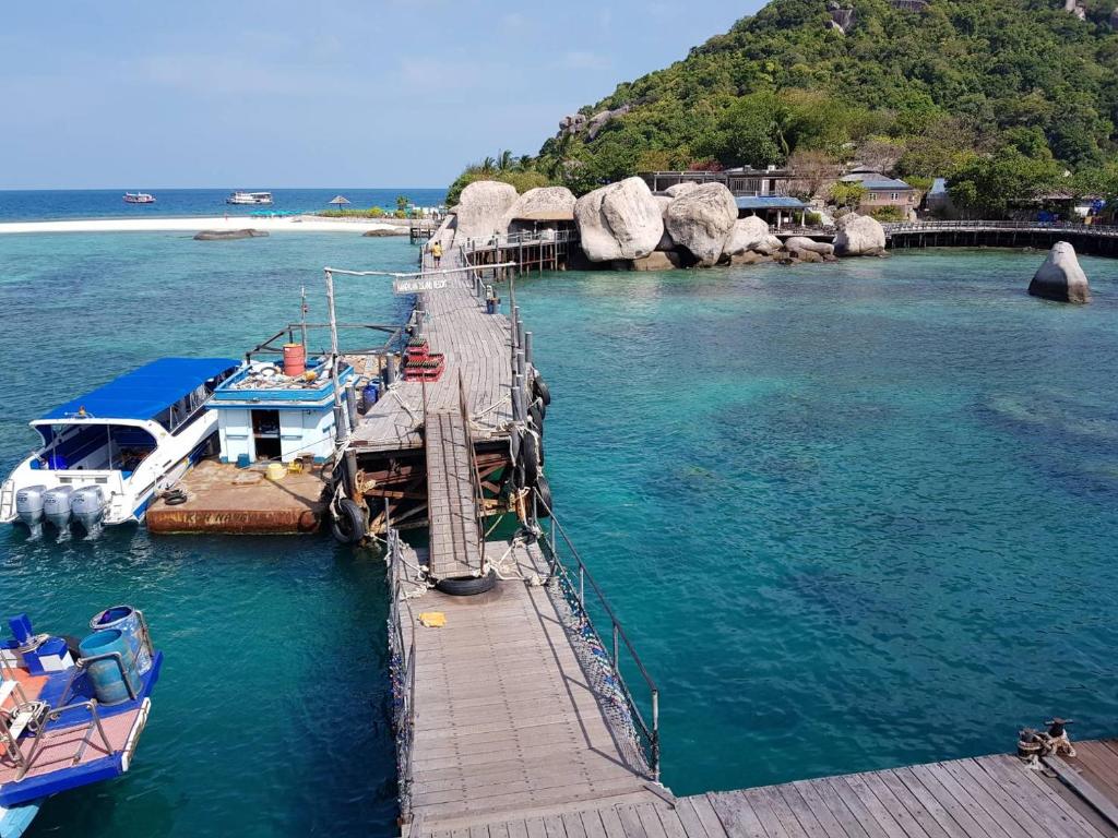 a dock with boats docked in the water at Nangyuan Island Dive Resort in Ko Tao