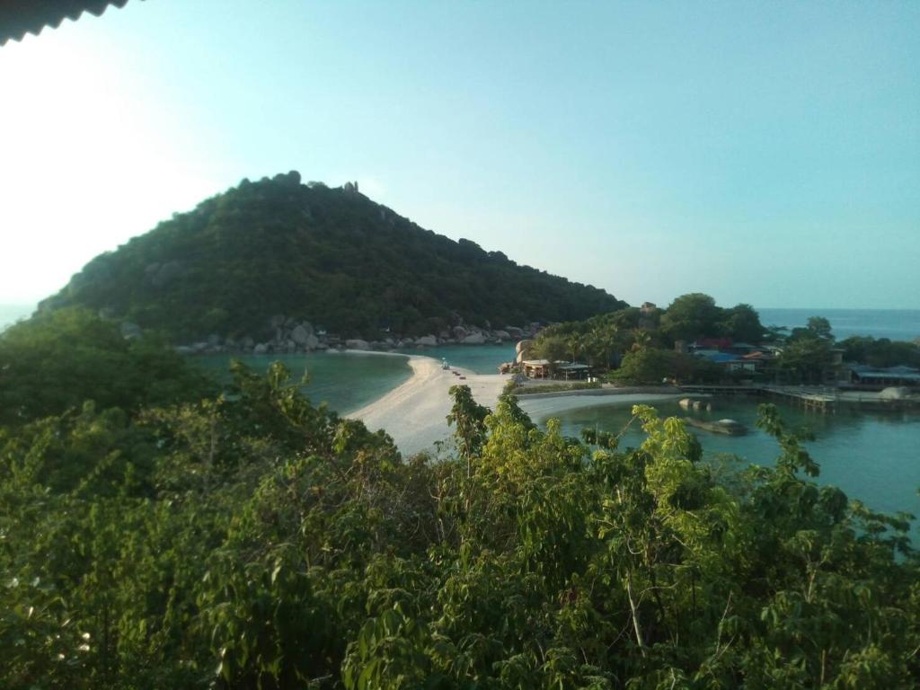 a small island in the middle of a body of water at Nangyuan Island Dive Resort in Ko Tao