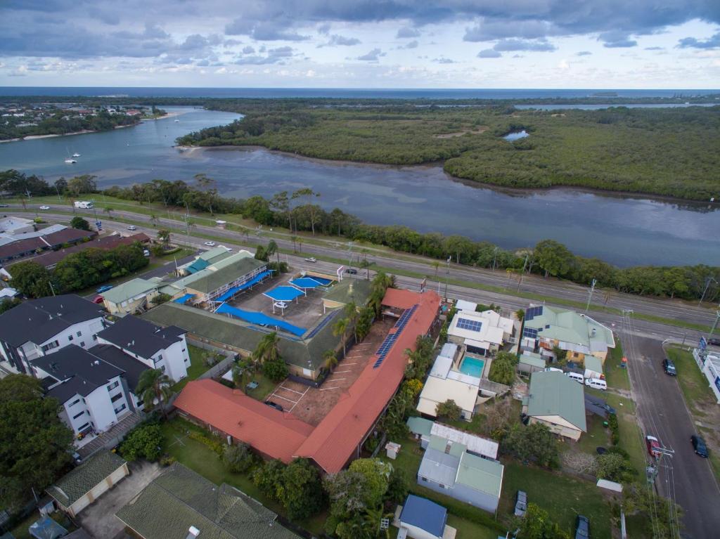 an aerial view of a house next to a river at City Lights Motel in Tweed Heads