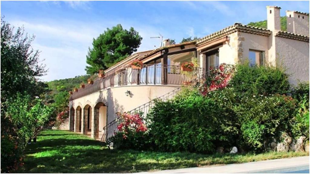 a house with a balcony on the side of it at Villa Ruzanna in Mandelieu-La Napoule
