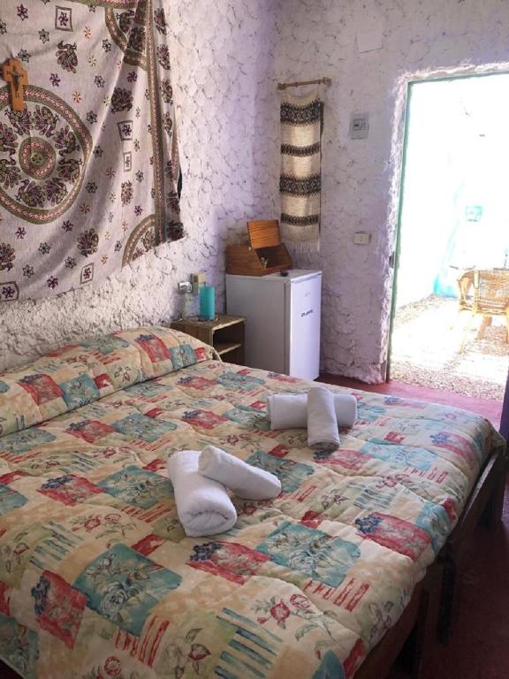 A bed or beds in a room at I Dammusi del Blu Green