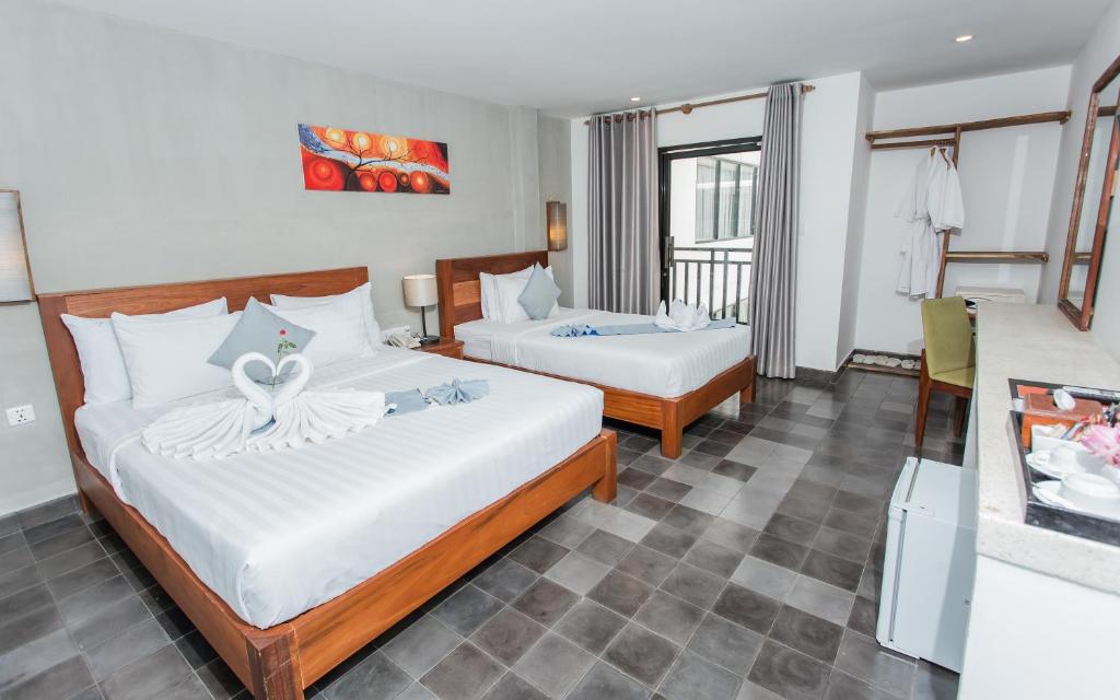 Postel nebo postele na pokoji v ubytování Home Chic Hotel