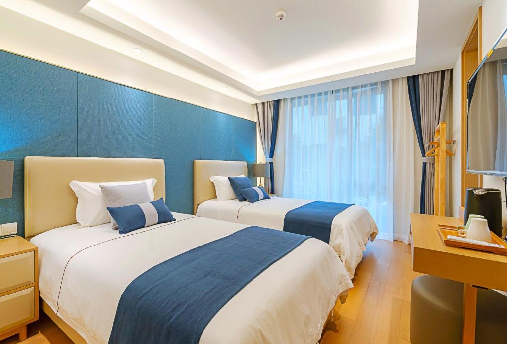 Postel nebo postele na pokoji v ubytování Hangzhou Ziwei Boutique Homestay