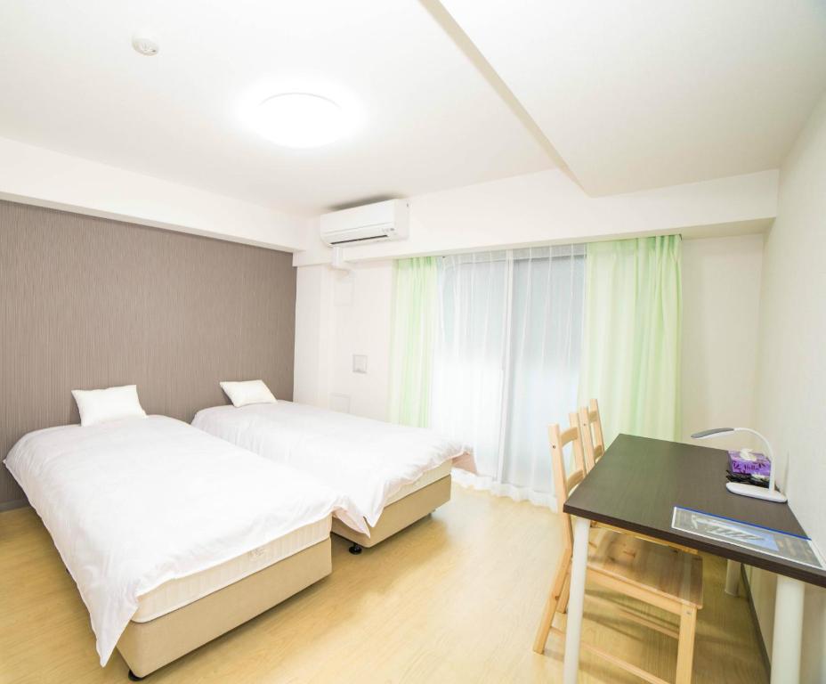 Postel nebo postele na pokoji v ubytování Universal Haneda