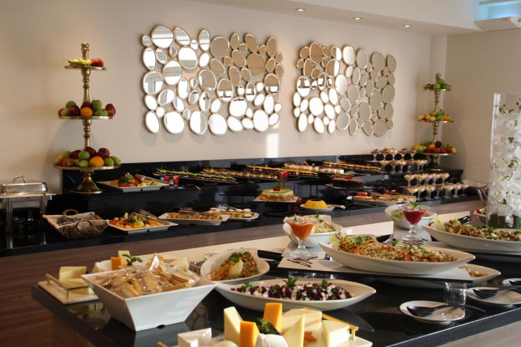 a buffet with many different types of food at Queens Bay Hotel in Paphos