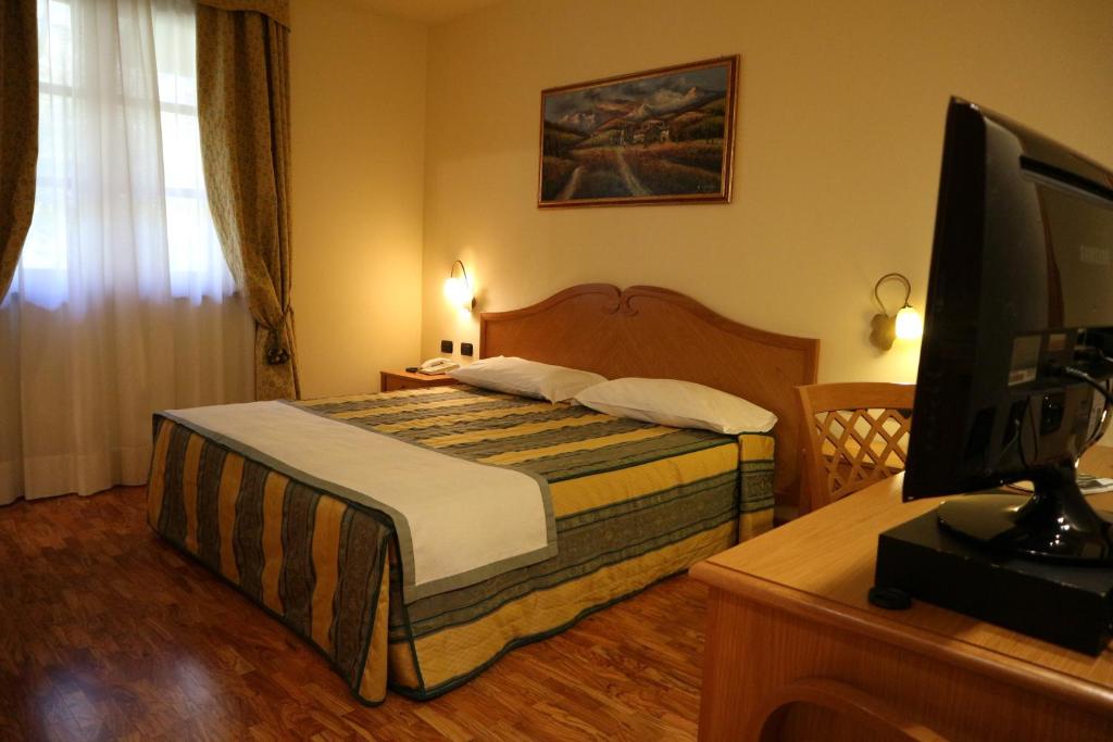 Postel nebo postele na pokoji v ubytování Hotel Camoretti