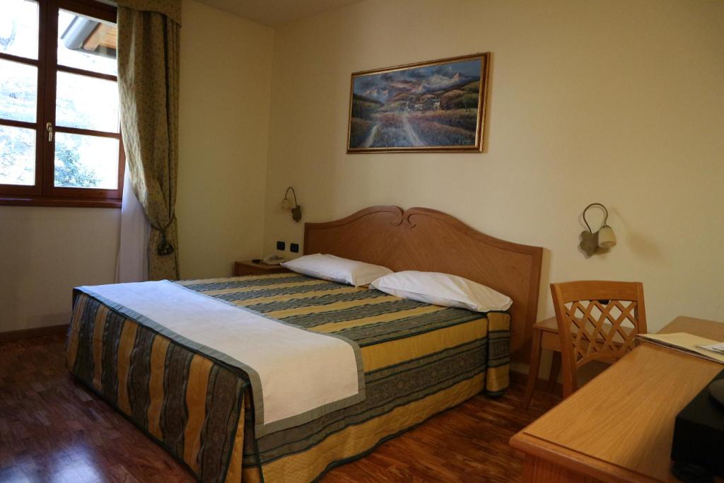 Postel nebo postele na pokoji v ubytování Hotel Camoretti