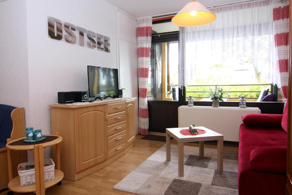 sala de estar con TV y sofá en Ferienwohnung Ostsee App. 6111, en Wendtorf