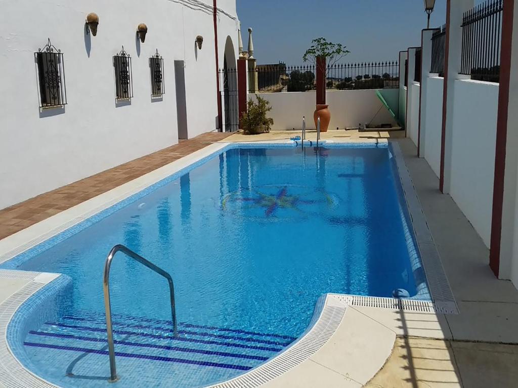 a swimming pool with blue water in a building at Venta del Alto Hotel las Cumbres by Vivere Stays in El Garrobo