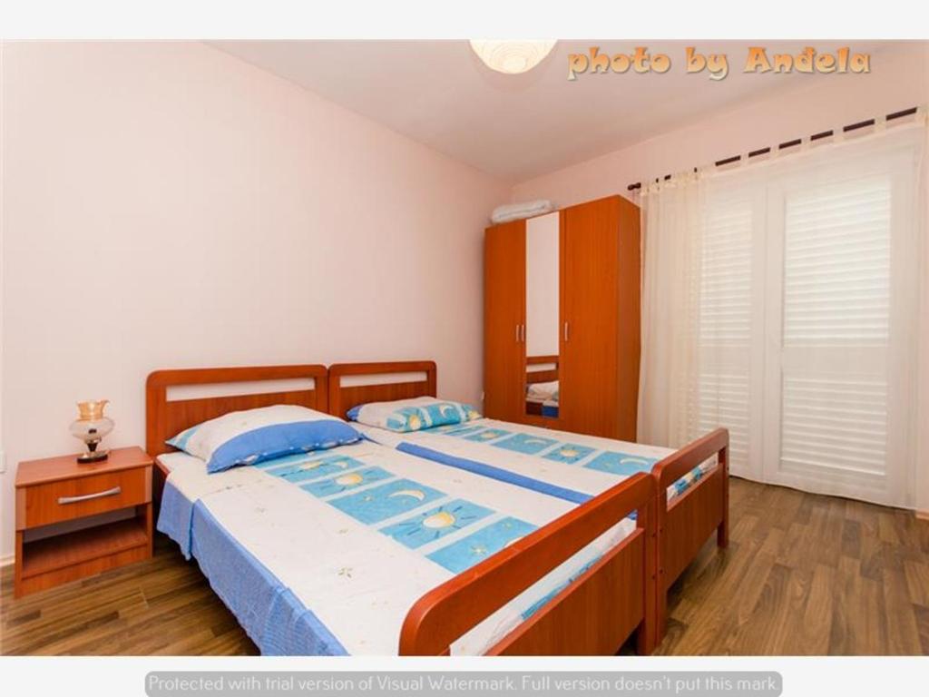 Posteľ alebo postele v izbe v ubytovaní Apartmani Anđela