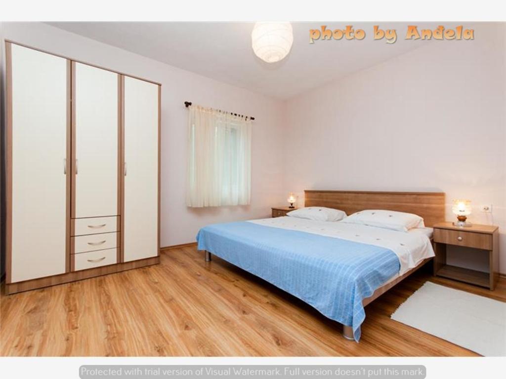 Posteľ alebo postele v izbe v ubytovaní Apartmani Anđela