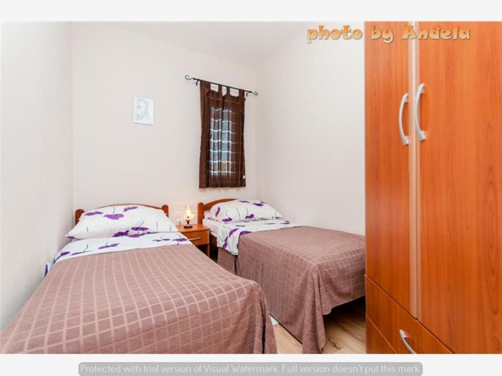 Posteľ alebo postele v izbe v ubytovaní Apartmani Anđela