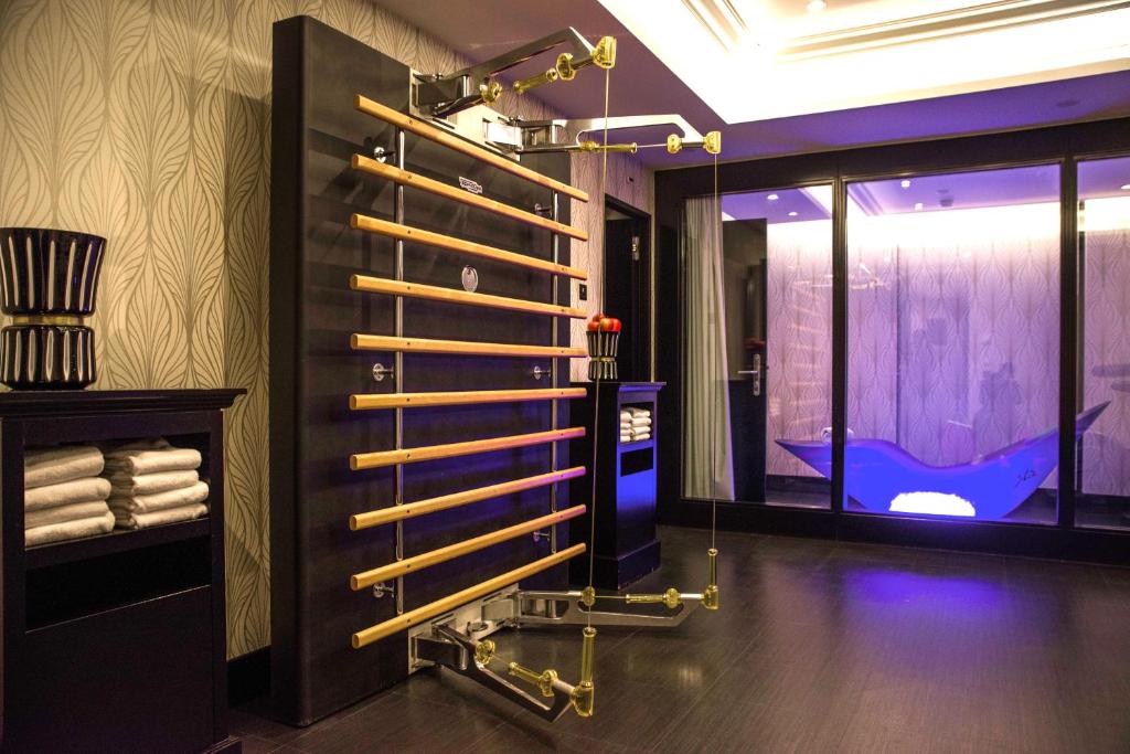 a bathroom with a shower and a tub in a room at Hôtel Tiffany by Fassbind in Geneva