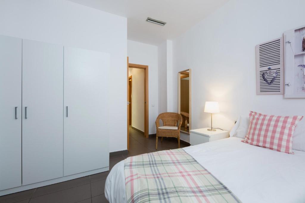Postel nebo postele na pokoji v ubytování Apartamentos Cornellalux