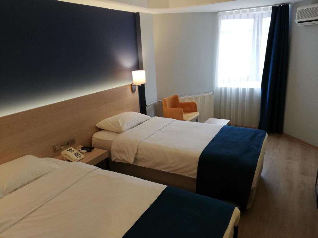 A bed or beds in a room at Piskin Hotel