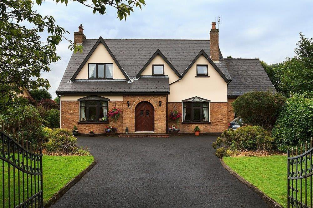 a house with a driveway in front of it at Woodview Lodge B&B in Castlebar