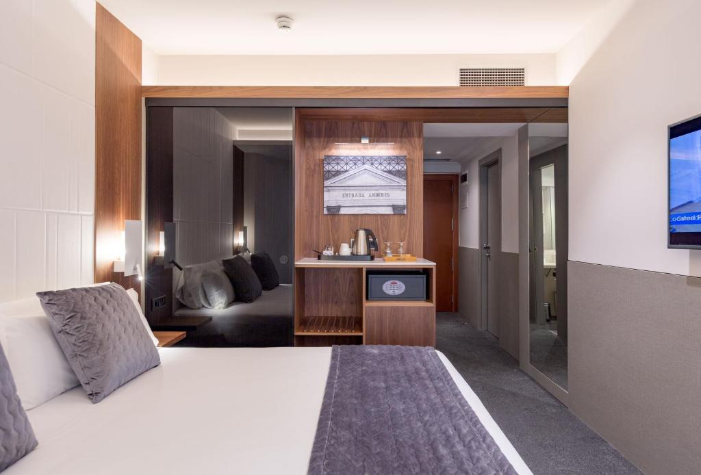 a hotel room with a bed and a tv at Best Western Premier Hotel Dante in Barcelona