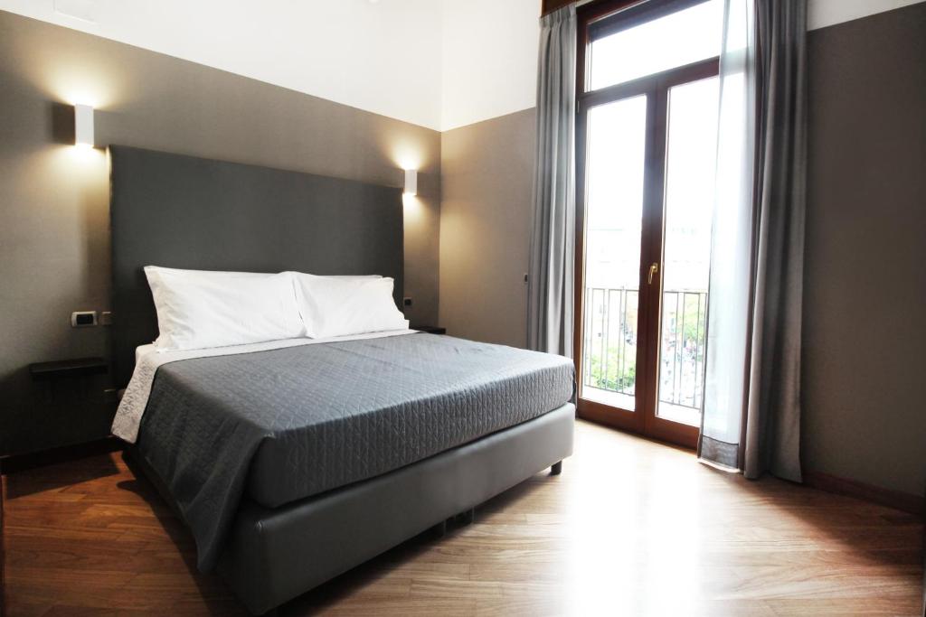 Posteľ alebo postele v izbe v ubytovaní Piazza Carità