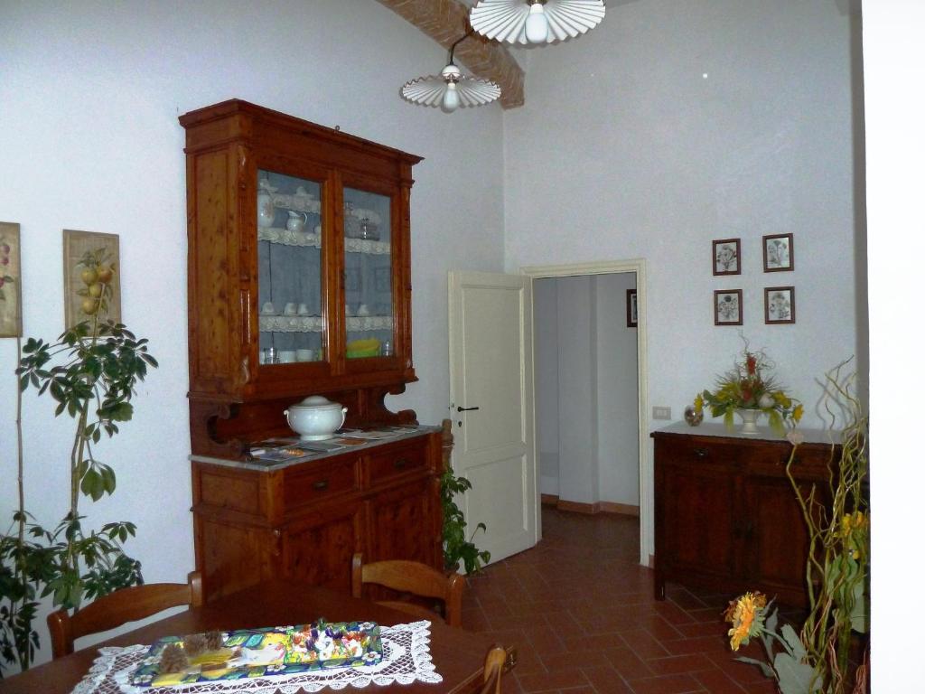 a dining room with a china cabinet and a table at Relais Il Colle Verde in Signa