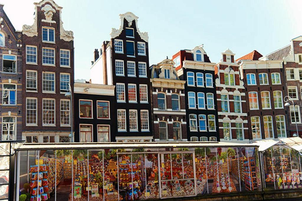 a market in front of buildings in a city at Top Of The City in Amsterdam