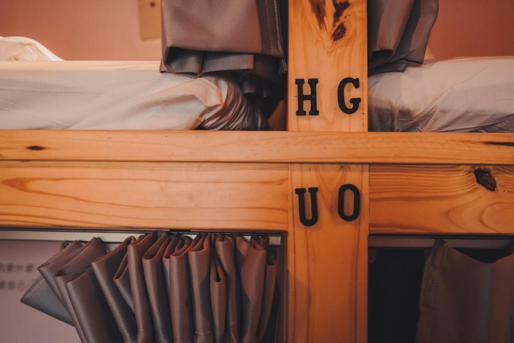 a wooden bunk bed with the word hog on it at Kenting Original Hostel in Kenting
