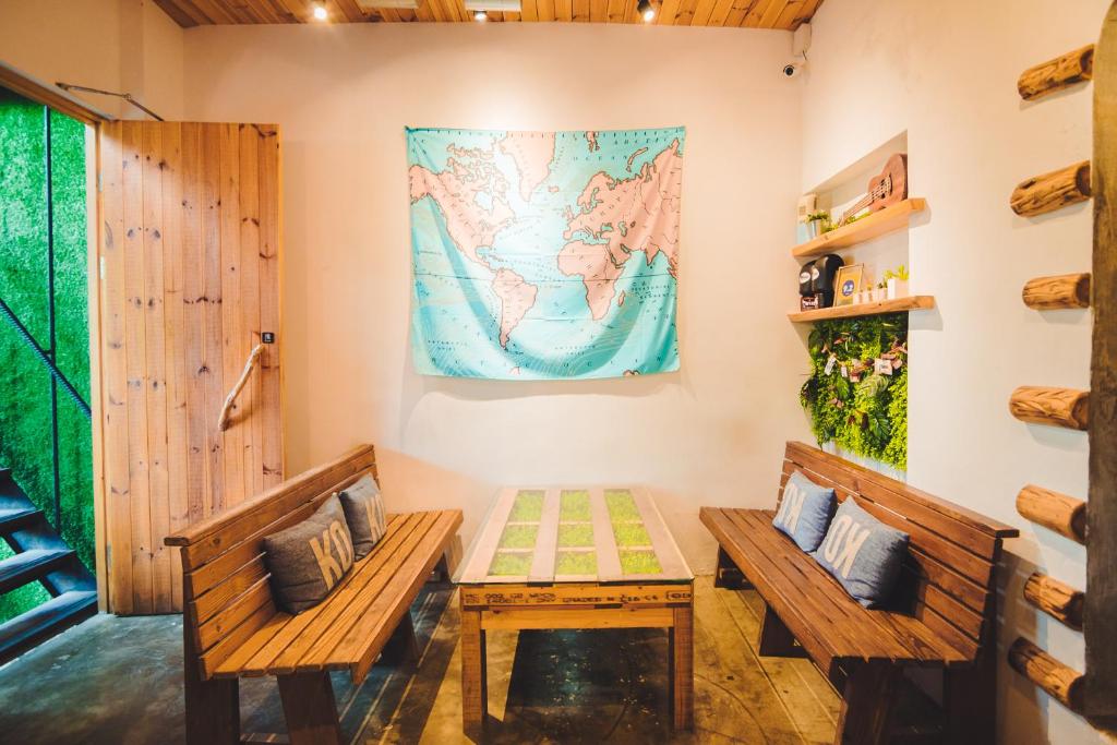 a room with two benches and a map on the wall at Kenting Original Hostel in Kenting