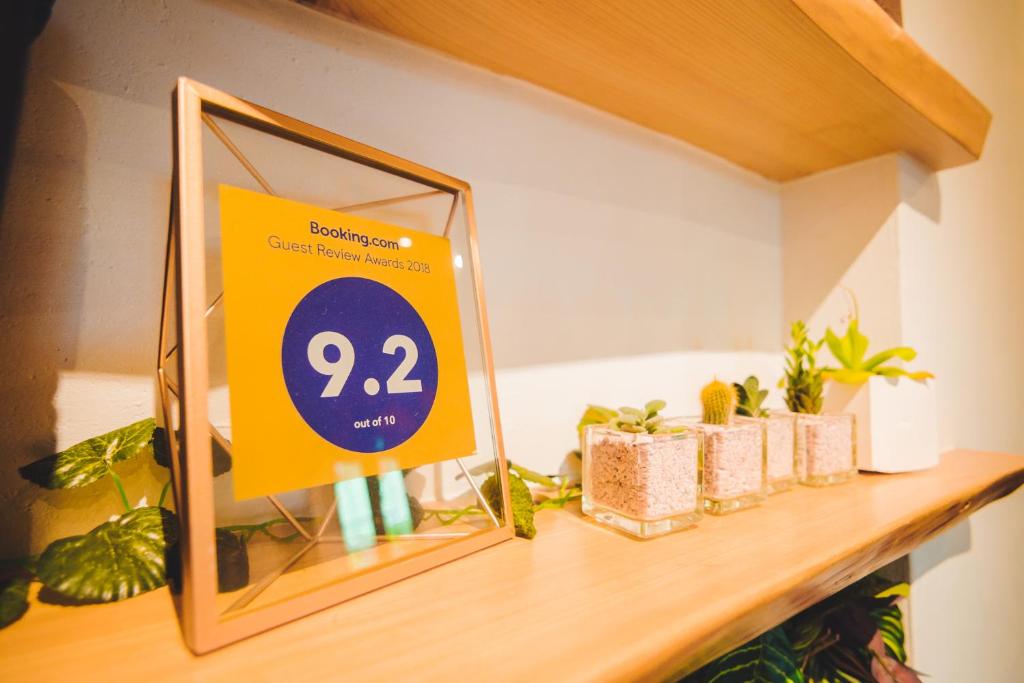 a yellow sign sitting on a shelf with plants at Kenting Original Hostel in Kenting