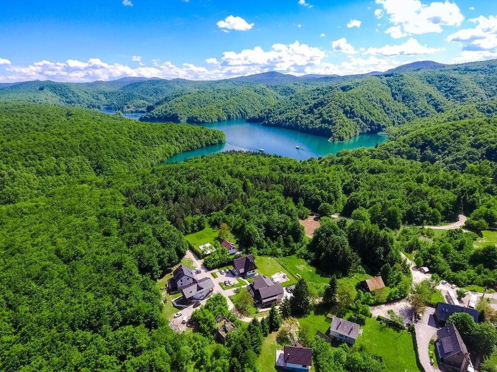 an aerial view of a home and a lake at B&B Plitvica Lodge in Plitvica selo