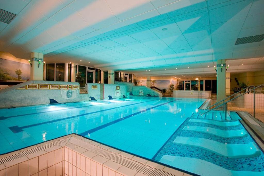 a large swimming pool in a large building at Ferienwohnung Marion 2 in Sankt Englmar