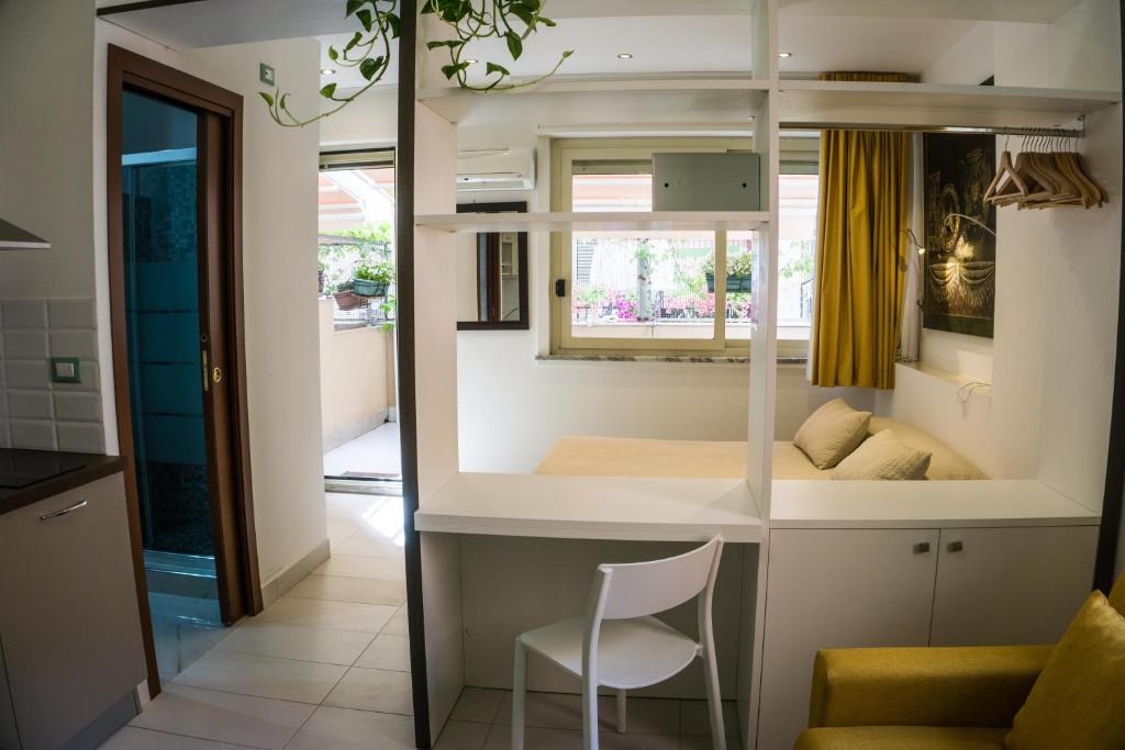 a small room with a bed and a chair at Tysandros Hotel Apartments in Giardini Naxos