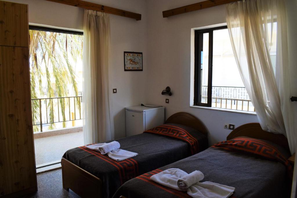 A bed or beds in a room at Esperia Home Style Pension