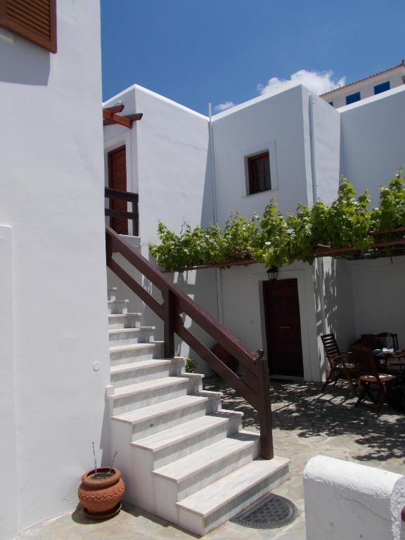 a staircase leading up to a white building at Sofirene Sea View in Batsi