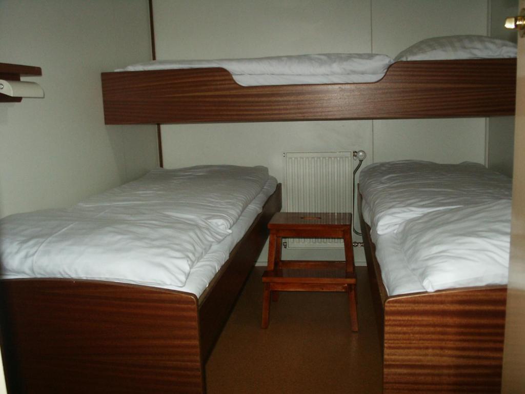 two bunk beds in a room with a side table at Felicitas in Amsterdam