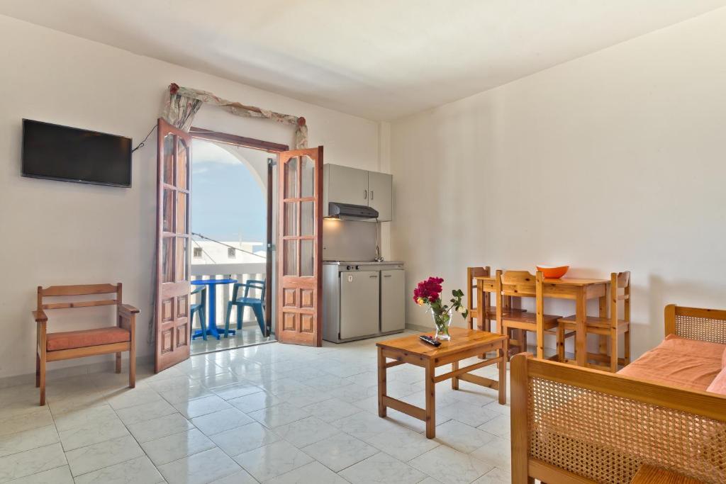 a living room with a kitchen and a dining room at Sea Stone Hotel in Karpathos