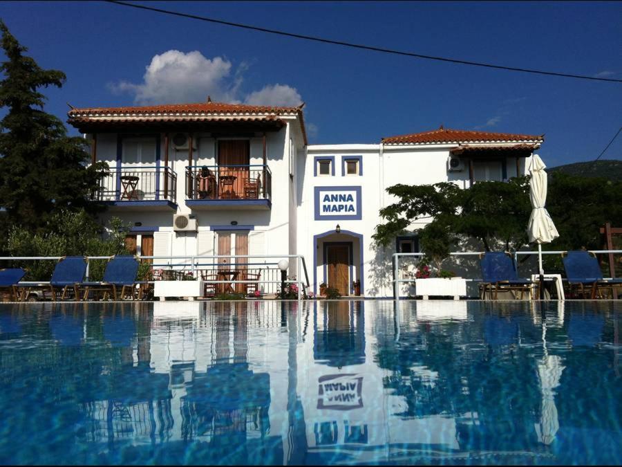 a hotel with a swimming pool in front of a building at Annamaria Studios & Apartments in Petra
