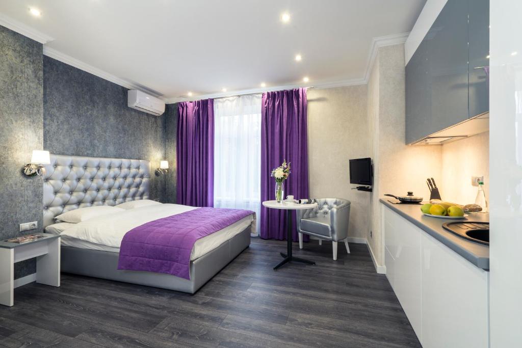 a hotel room with a bed and a kitchen at Apartments in City Center Area in Kyiv