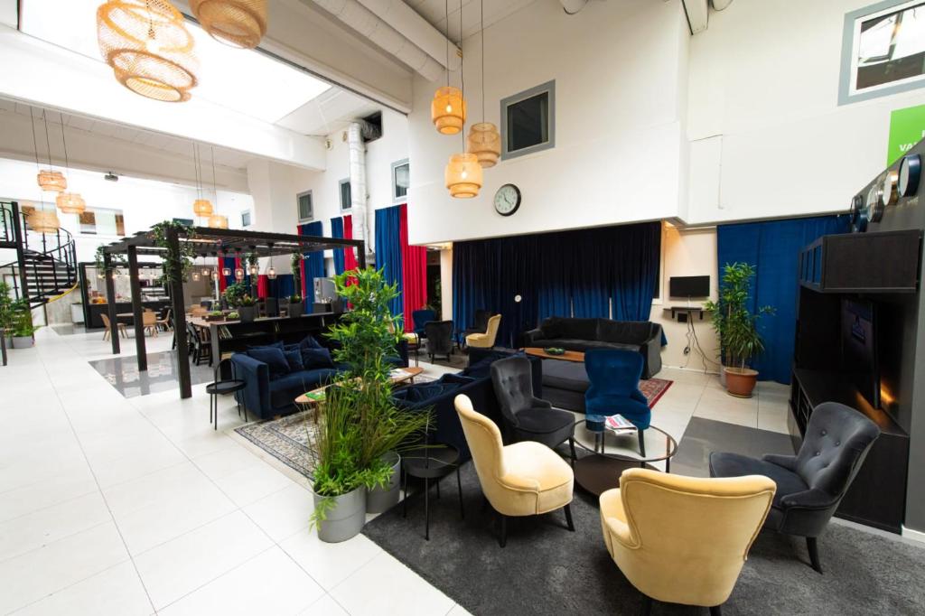 a lobby with couches and chairs and a table at Hotell Kvarntorget in Uppsala