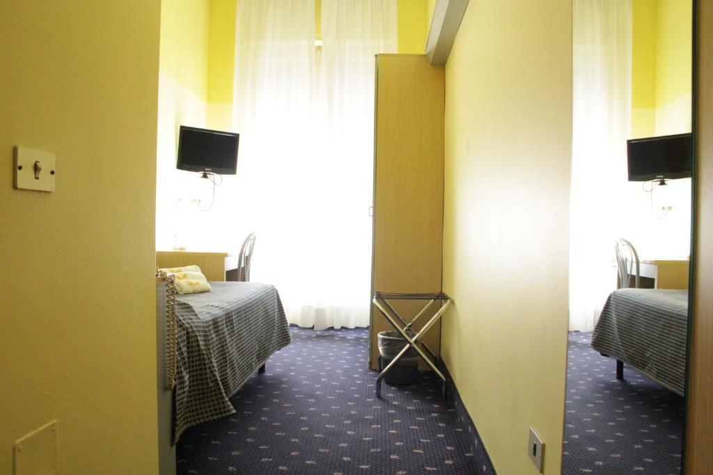 Łóżko lub łóżka w pokoju w obiekcie Hotel Lugano