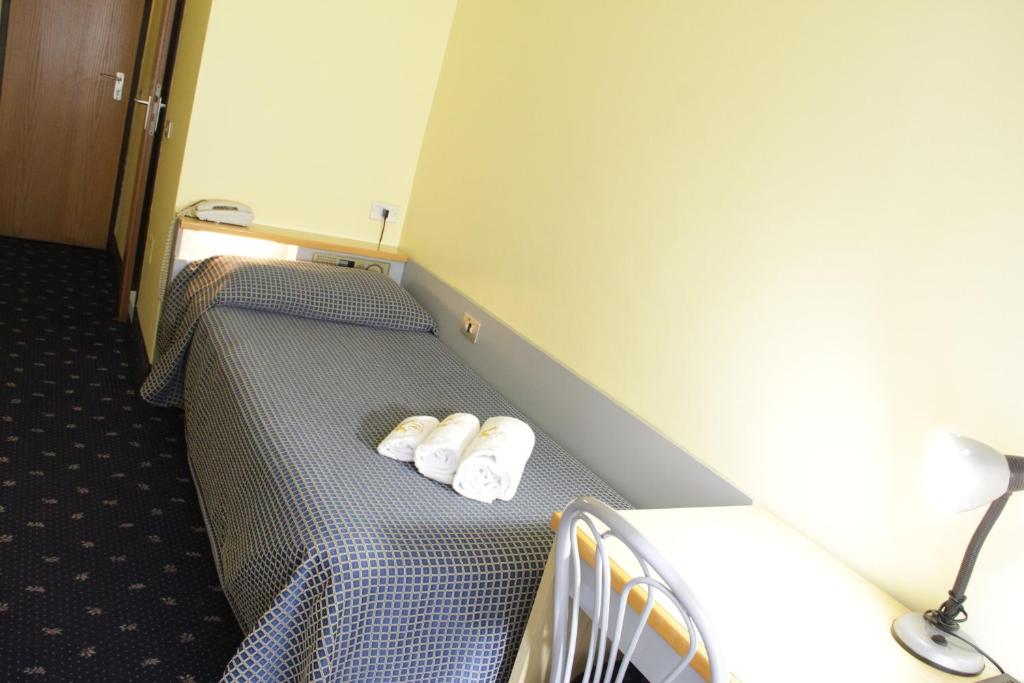 Łóżko lub łóżka w pokoju w obiekcie Hotel Lugano